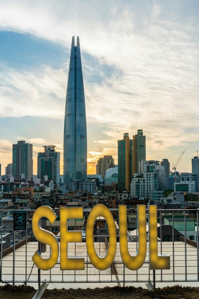 Stunning view of Lotte Tower and Seoul's skyline during sunset, highlighting the city's urban architecture.